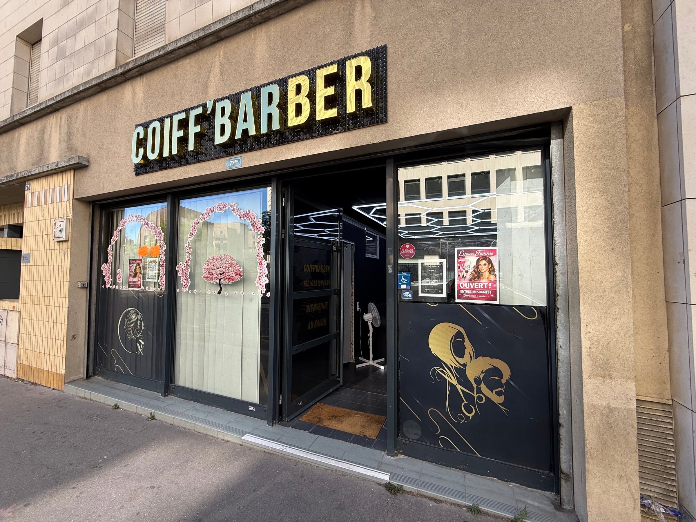 La façade du salon rue du Dessous des Berges : enseigne dorée, vitrines décorées d'arches de fleurs